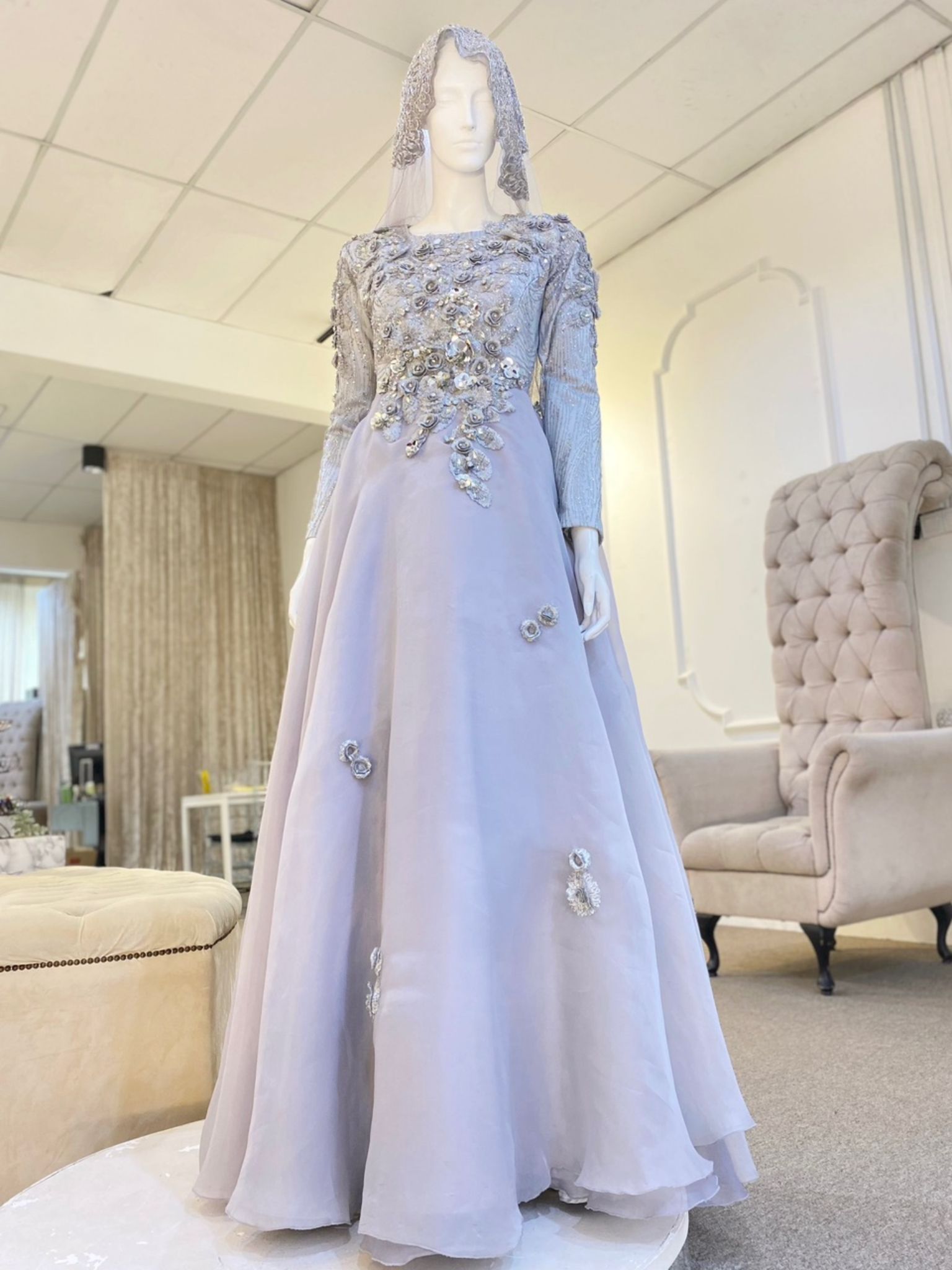 Madeleine is a stunning silver grey glitter lace ballgown muslimah dress that is perfect for the modern bride. With its elegant design and flattering fit, Madeleine is sure to turn heads on your big day. Made from luxurious glitter lace and organza, this dress is the perfect way to celebrate your special day.