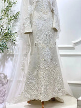 Lower skirt and songket texture of Off White Baju Pengantin with smooth structured hem-Bottom detail suited for Sewa Baju Sanding customers comparing fabric and finish