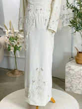 close-up image of ARABELLE, a White lace dress on a mannequin with a neutral background