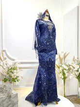 Bonita is a celebration of strength and elegance. The bold royal blue with silver songket stands out beautifully under wedding lights, creating a commanding yet refined look. 