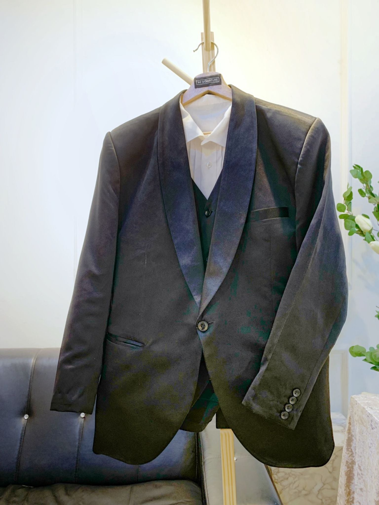 A close-up image of a black wedding suit with a shawl lapel. The suit is made from high-quality duchess fabric and is fully lined for a comfortable fit. It is the perfect choice for a formal occasion, such as a wedding or black tie gala.