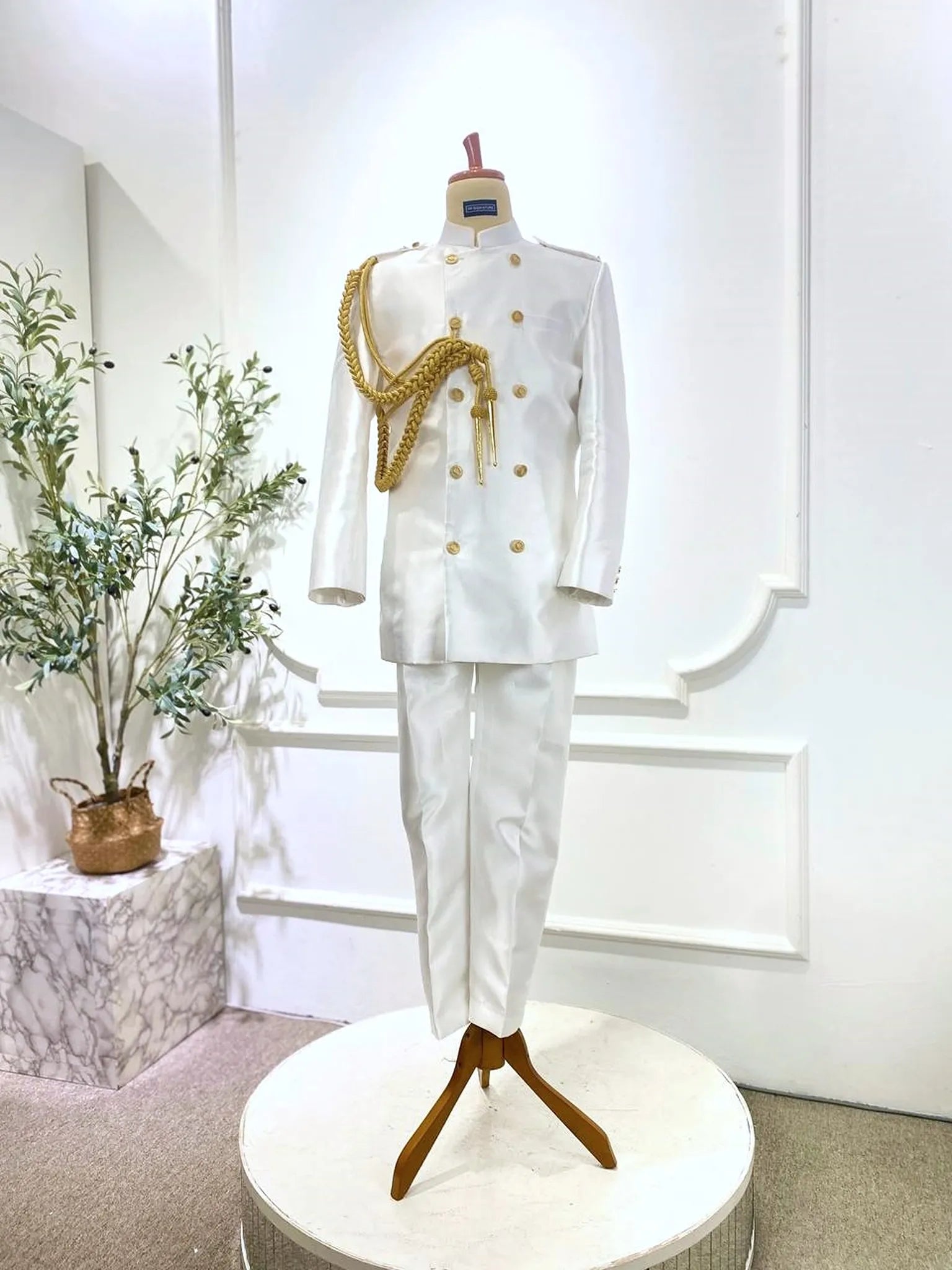 Front view of Off White Gold Captain Suit with pants presented for Sewa Baju Sanding-Modern groom look from PP Signature Bridal with sharp, structured Twill silhouette