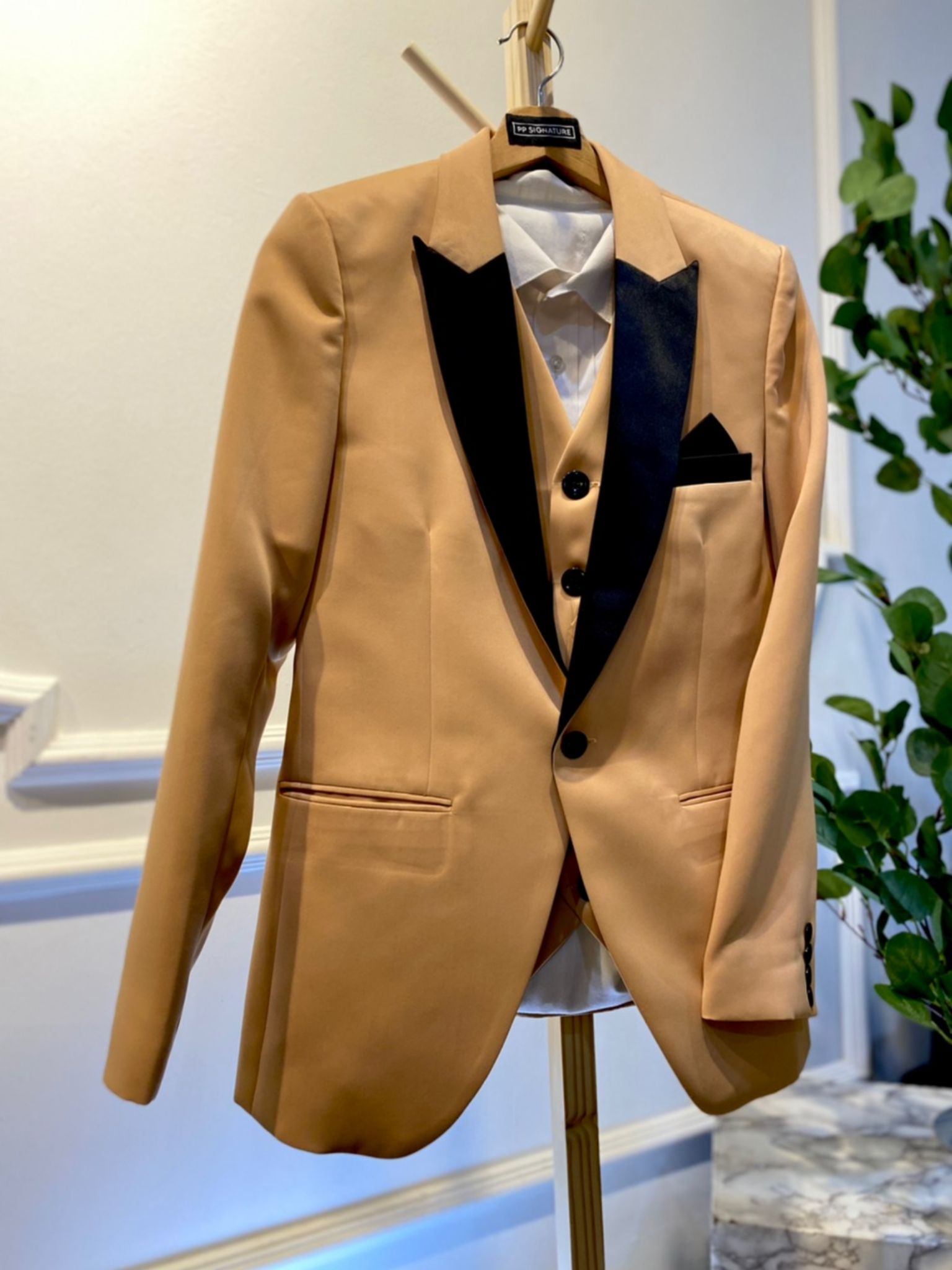 This Champagne 3 Piece Wedding Suit Brown with Black Peak lapel tuxedo jacket is the perfect choice for any formal occasion. Made from high-quality duchess fabric, it is both stylish and comfortable. The jacket features a classic single-breasted design with a peak lapel and satin trim. It also has two side pockets and one breast pocket. This jacket is available in a variety of sizes to fit all body types.
