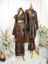 DARAWATI Baju Sanding Songket Dark Brown Kebaya with Selempang Sulam Biku from Butik Pengantin PP Signature. Made with Songket 3D fabric, this elegant dress features a traditional kebaya design and silver and chrome detailing.