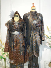 DARAWATI Baju Pengantin Dark Brown Songket Kebaya with Selempang Sulam Biku from Butik Pengantin PP Signature. This wedding reception dress features elegant Songket 3D fabric in dark brown with silver and chrome accents.