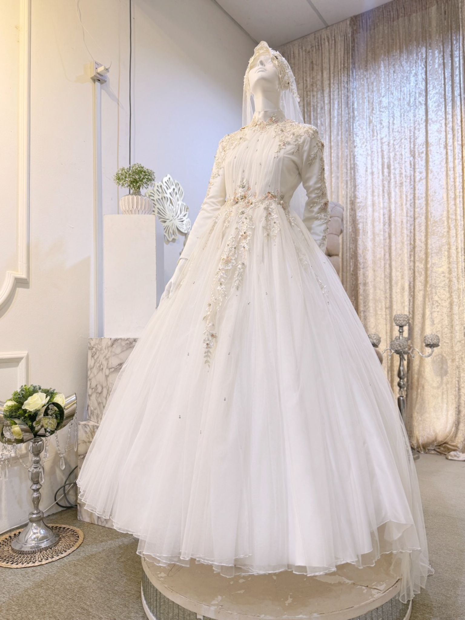 ELIZABETH  offers a mesmerizing ensemble for both bride and groom. Crafted from luxurious Duchess fabric with delicate lace detailing, the bride's attire features a stunning Ballgown design, while the groom can choose between a classic Suit or the intricate Kot Raihan Three-Piece ensemble. Available in sizes M to XL for both partners, this remarkable set is priced at MYR 850.00, down from RM1000.
