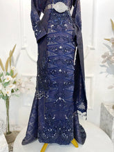 GEMAWAN Baju Sanding Tradisional Navy Blue Songket Dress with Selempang Sulam from Butik Pengantin PP Signature. This traditional wedding reception dress showcases intricate Songket 3D fabric with purple and light gold accents-pakej perkahwinan-baju pengantin-baju sanding-butik pengantin kajang-butik pengantin pp signature-planet pengantin