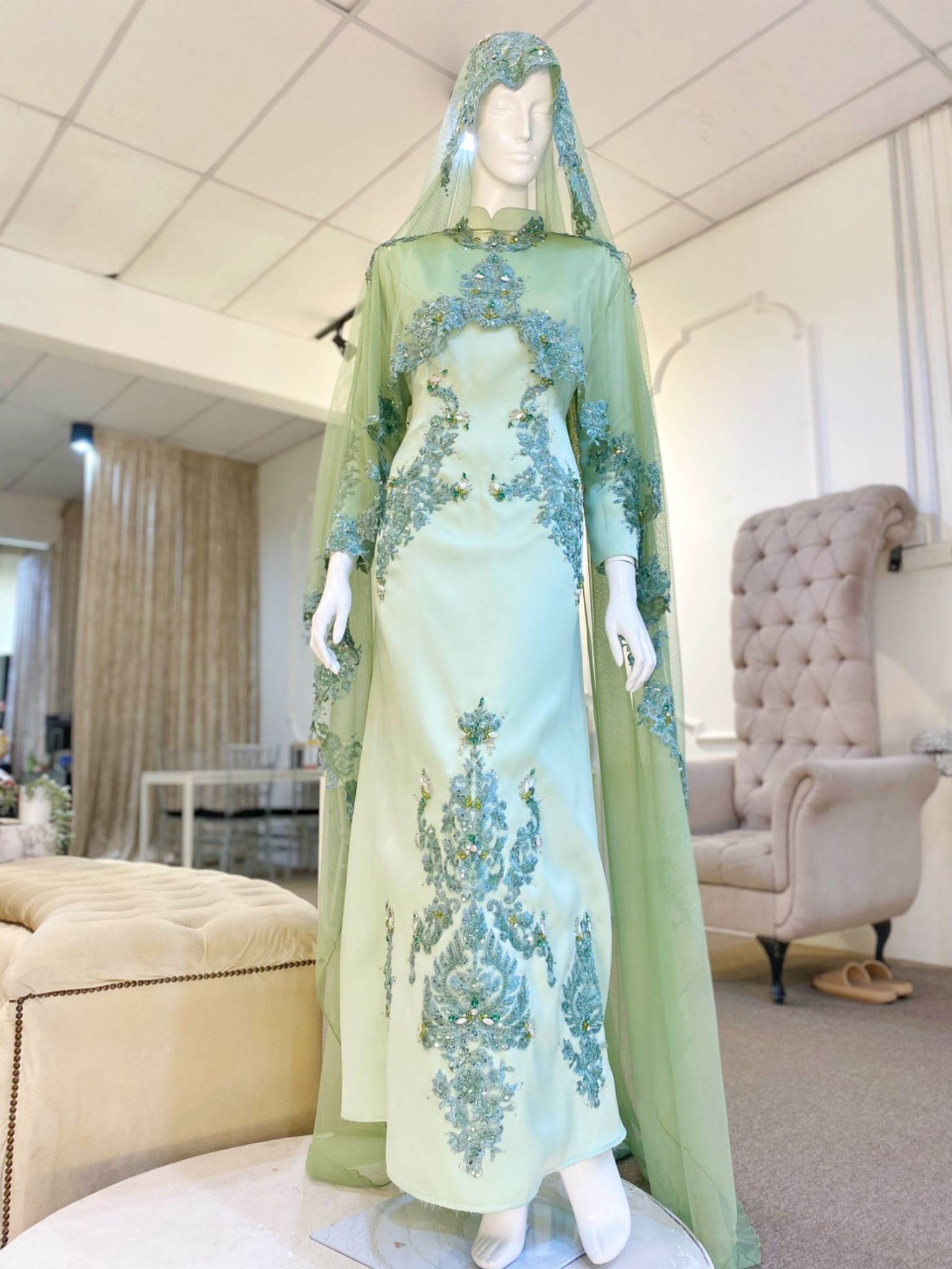 Hajar is an elegant olive green double face wedding dress with a detachable cape that is perfect for the modern bride. With its unique design and flattering fit, Hajar is sure to turn heads on your big day. Made from luxurious double face fabric, this dress is the perfect way to celebrate your special day in style.