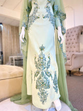 Hajar is an elegant olive green double face wedding dress with a detachable cape that is perfect for the modern bride. With its unique design and flattering fit, Hajar is sure to turn heads on your big day. Made from luxurious double face fabric, this dress is the perfect way to celebrate your special day in style.