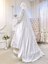 Immerse yourself in sophistication with Jasmine, a captivating ensemble tailored for both the bride and groom. The image showcases the bride's attire, crafted from luxurious Duchess fabric with delicate lace detailing, featuring a stunning Ballgown design paired with a graceful petticoat. Meanwhile, the groom radiates elegance with a choice between a classic Suit or the intricate Kot Raihan Three-Piece ensemble.