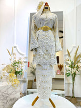 Close-up of KUNTOM Baju kurung Sanding 3D songket fabric in cream, gold, and silver