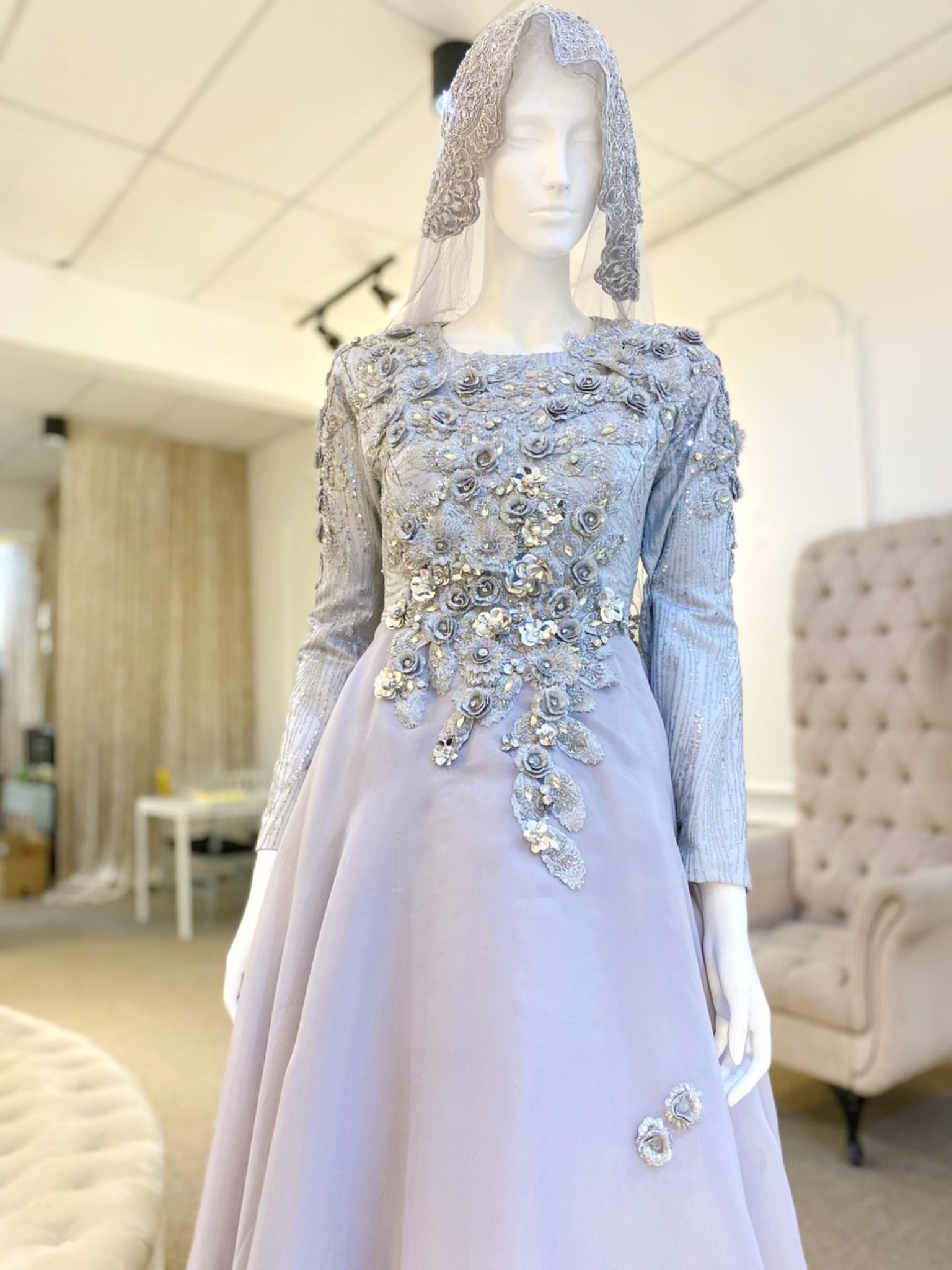 Madeleine is a stunning silver grey glitter lace ballgown muslimah dress that is perfect for the modern bride. With its elegant design and flattering fit, Madeleine is sure to turn heads on your big day. Made from luxurious glitter lace and organza, this dress is the perfect way to celebrate your special day.