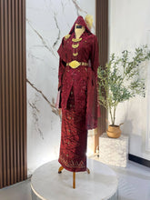 Bride wearing maroon songket 2D kebaya with embroidered selempang for Malay wedding reception