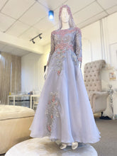 Matilda is a stunning silver grey and dusty pink ballgown muslimah dress that is perfect for the modern bride. Made from luxurious lace and organza, this dress is sure to turn heads on your big day. With its elegant design and flattering fit, Matilda is the perfect dress to make you feel confident and beautiful on your wedding day.