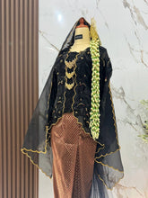 Close-up detail of NILAKANDI black kebaya kutubaru top and groom javanese beskap suit dokoh