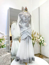 PALOMA Baju Sanding Songket Off White Two-Piece Tulip Dress from Butik Pengantin PP Signature. This wedding reception dress is crafted from fine Songket 2D fabric, offering a traditional yet sophisticated look for your special day.