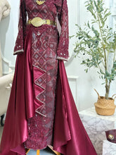 Bottom part of Baju Sanding skirt with intricate songket patterns and detachable trail-Close-up of kain songket maroon with silver woven design on Baju Pengantin Perempuan