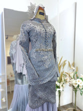 Top detail of Baju Pengantin Perempuan with tulip cut and metallic silver thread songket-Close-up of neckline and bodice in 2D songket with modern Malay bridal styling