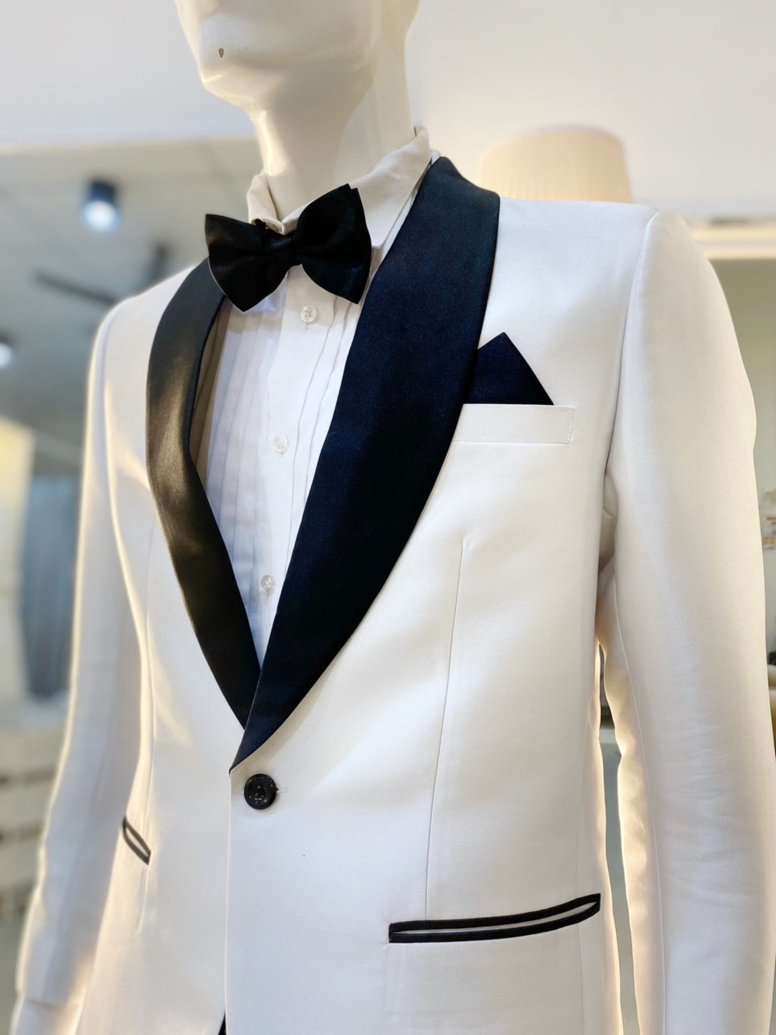 Signature Suit (White 1): A man in a white tuxedo with a shawl lapel. He looks confident and stylish, ready to make a lasting impression at his next formal event. The tuxedo is made from luxurious Mikado fabric and is perfect for weddings, galas, and any other special occasion-tuxedo-white-tuxedo-pearl-white-tuxedo-shawl-lapel-tuxedo-formal-wear-wedding-attire-gala-attire-men's-suits-mikado-fabric-affordable-luxury-rental