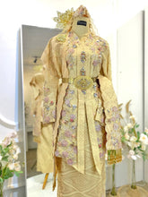 Bride in a full-length shot wearing the SRI ENONG baby pink kebaya songket with a selempang sulam