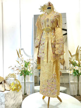 Bride in a full-length shot wearing the SRI ENONG baby pink kebaya songket with a selempang sulam
