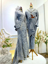 Elegant light grey songket dress with dark grey details for Malay wedding reception.