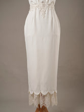 Close-up of the skirt and hem on TULIP preloved baju nikah, off white bridal satin pencil dress