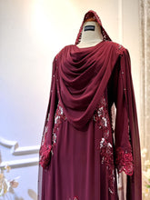 WARDINA offers a captivating Baju Pengantin ensemble in Maroon Burgundy, tailored for your wedding reception (Baju Sanding). The bride's attire features a graceful loose dress with an elegant shoulder cape, while grooms can choose between the classic Prince Suit or the traditional Kot Raihan 3-piece set. Crafted from luxurious chiffon material, this ensemble epitomizes sophistication and style, ensuring a memorable presence for both bride and groom on their special day.