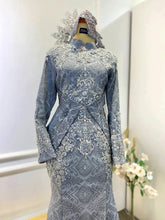 Elegant light grey songket dress with dark grey details for Malay wedding reception.