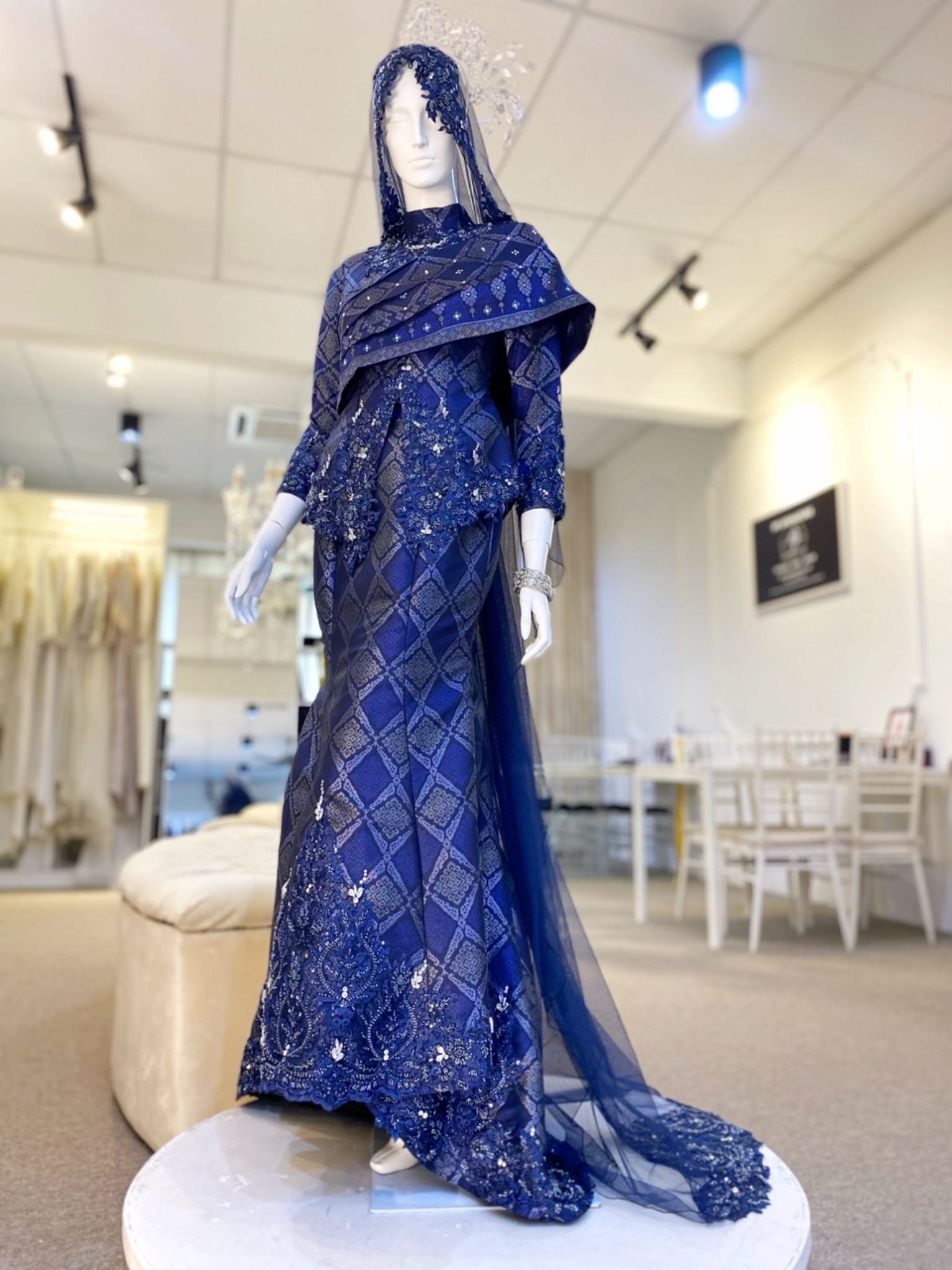 BETTY - Baju Pengantin Two-Piece Dress Navy Blue Songket with Beaded Lace Detailing. Modern and elegant baju pengantin with navy blue songket fabric, featuring delicate beaded lace detailing on the bodice. Perfect for a modern Malay wedding. Available for rent in Malaysia and Singapore.