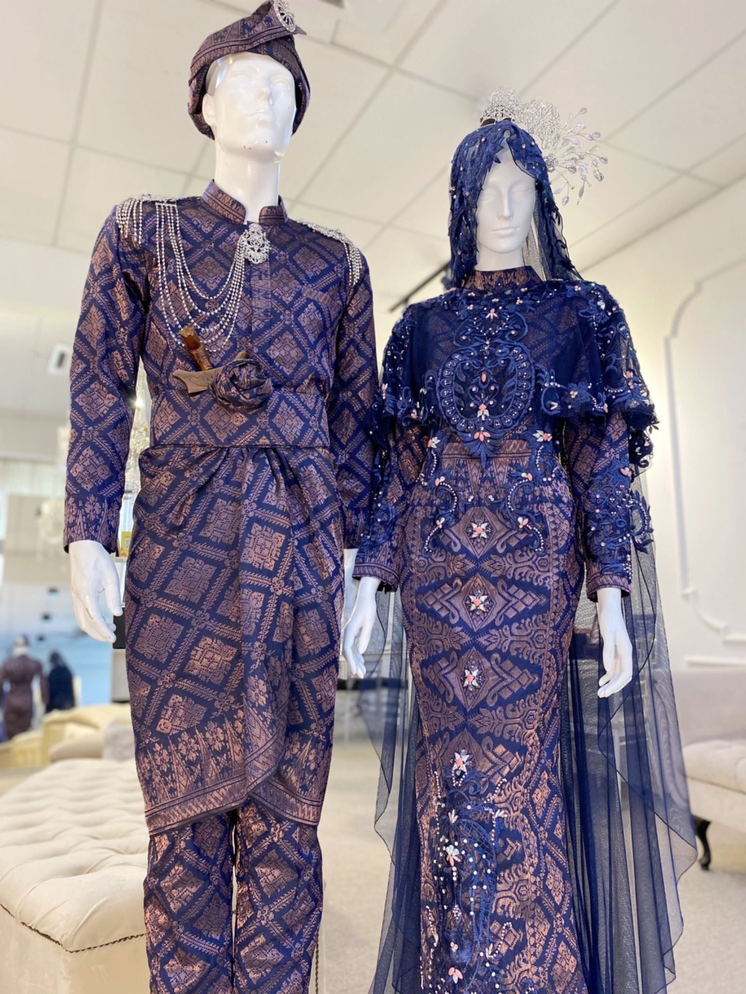 BLOSSOM EMPRESS - Baju Pengantin A-line Loose Dress Navy Blue and Dusty Pink Songket with Detachable Cape. Modern and elegant baju pengantin with navy blue songket fabric, featuring delicate beaded lace detailing on the bodice. Perfect for a modern Malay wedding. Available for rent in Malaysia and Singapore..