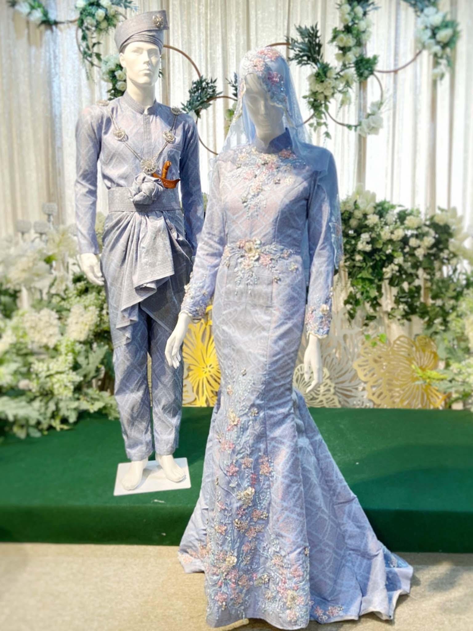 The UNICORN Baju Pengantin Songket Dusty Blue Trumpet Dress with Silver Lace is made from high-quality Songket fabric and features a beautiful trumpet silhouette.