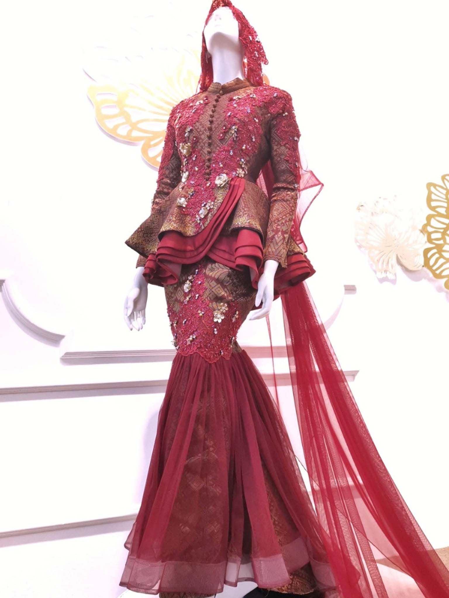 Sepasang Baju Pengantin Two Piece Peplum Dress lengkap aksesori oleh Butik Pengantin PP Signature dipakai patung Lelaki dan perempuan berwarna merah maroon untuk disewa-A pair of Two Piece Peplum Dress wedding dresses songket complete with accessories by PP Signature Bridal Boutique worn by male and female statues in maroon for rent