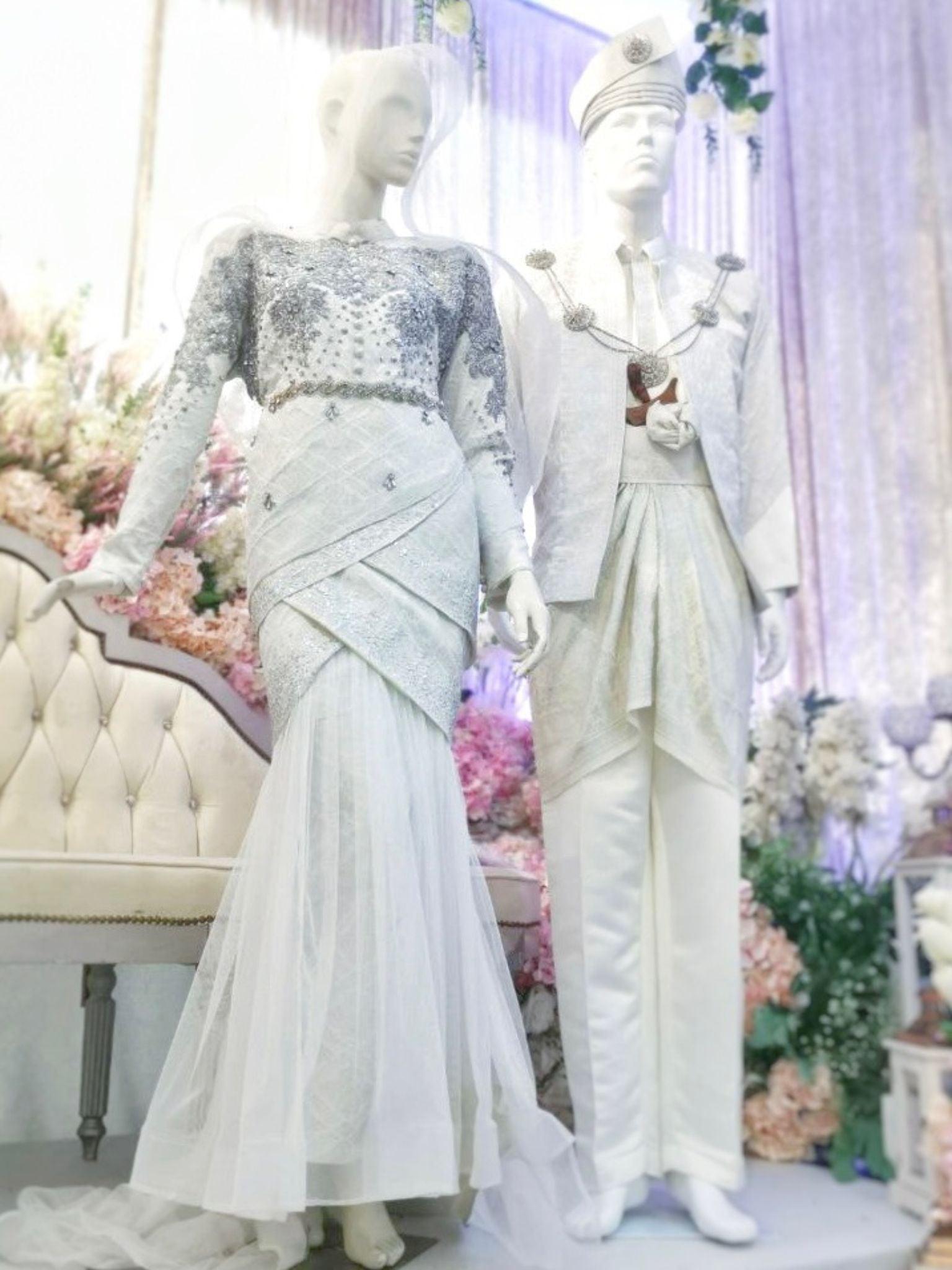 Sepasang baju pengantin songket, Two-Piece Tulip Dress berwarna putih dan kelabu perak lengkap aksesori buatan Butik Pengantin PP Signature-a pair of songket wedding dresses, Two-Piece Tulip Dress in off white and silver complete with accessories by PP Signature Bridal Boutique