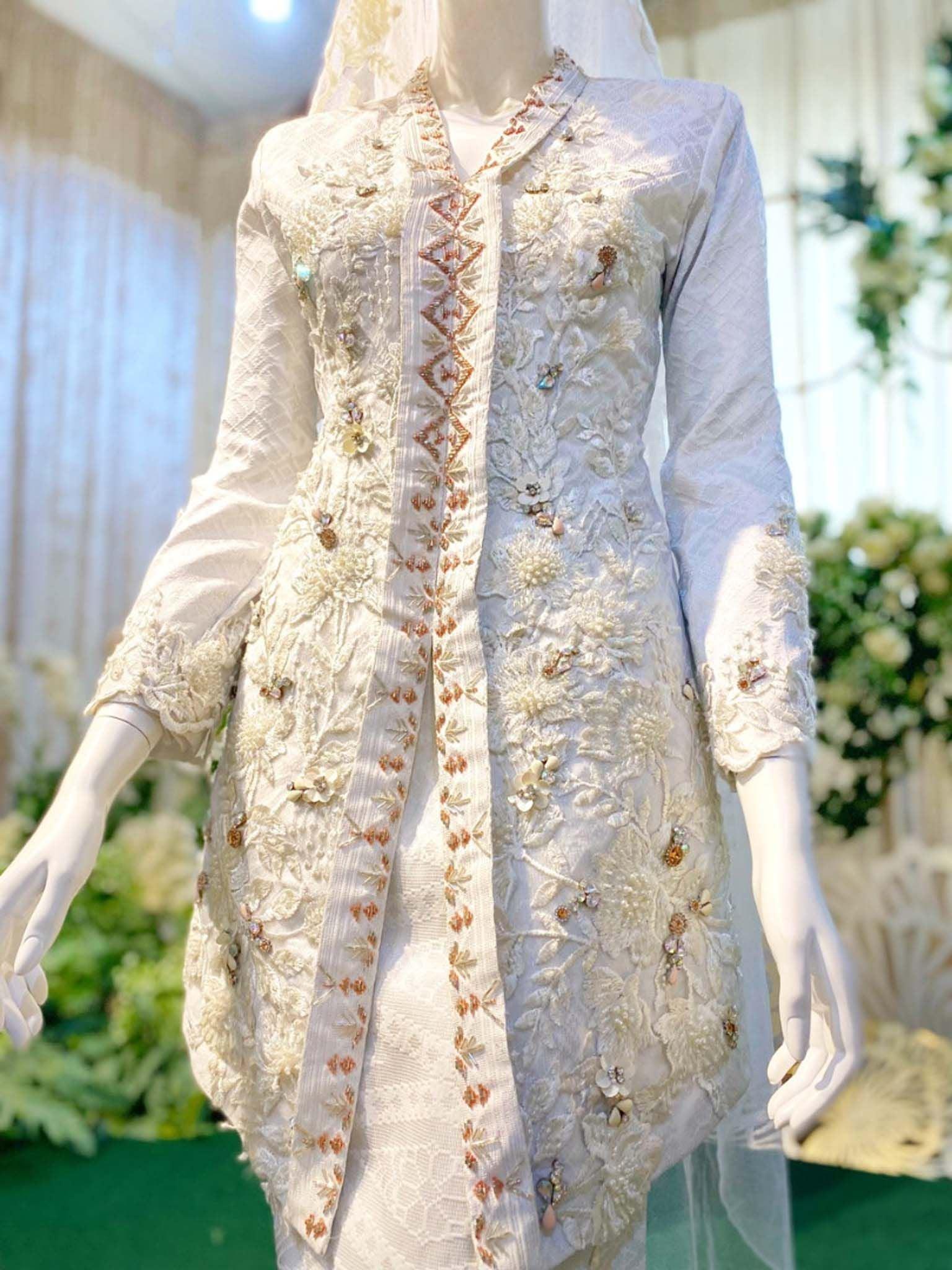 Sepasang baju pengantin songket, baju Kebaya berwarna putih lengkap aksesori buatan Butik Pengantin PP Signature-A pair of songket wedding dresses, Kebaya Dress in off-white complete with accessories made by PP Signature Bridal Boutique